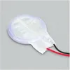 A close-up, slightly angled view of a round, flat electronic component with two wires attached. Produktbild-Vorschau