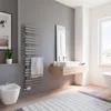 A modern bathroom with a bidet, sink, towel warmer, and a large window. Produktbild-Vorschau