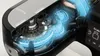 A cutaway view of a kitchen machine's internal gears and motor, with glowing blue lines indicating energy flow. Produktbild-Vorschau