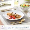 A table setting with a plate of spaghetti, a salad bowl, and cutlery. Produktbild-Vorschau
