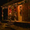 A house decorated with Christmas lights and garlands for the holidays. Anteprima dell’immagine prodotto