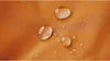 Close-up of water droplets on an orange textured surface. Náhled obrázku produktu
