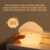 A hand is shown pinching a mushroom-shaped night light, which is illuminated. Text overlays describe its features. Podgląd zdjęcia produktu