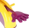 A close-up shot of a toy with a purple hand extended from a yellow base. Podgląd zdjęcia produktu