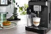 A coffee machine is making a latte next to a donut and a vase. Voir les images du produit