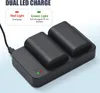 A dual battery charger with two batteries inserted, connected to a USB cable. Text overlays explain the LED indicator lights. Náhled obrázku produktu