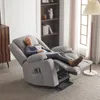 A woman is relaxing in a gray recliner chair in a living room. Podgląd zdjęcia produktu