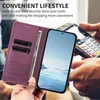 A person is holding a purple phone case with a phone inside, and another person is using a credit card machine in the background. Náhled obrázku produktu