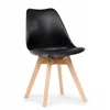 A black dining chair with wooden legs against a white background.