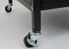 Close-up of the casters on a black cabinet. Anteprima dell’immagine prodotto