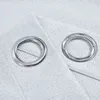Two metal grommets are shown on a textured light gray fabric. Produktbild-Vorschau