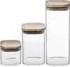 Three glass jars of varying sizes with wooden lids are displayed against a white background. Anteprima dell’immagine prodotto