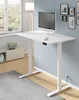 A white standing desk with a computer, keyboard, and mouse on top, placed in a room with a window and a cabinet. Podgląd zdjęcia produktu