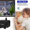 An aquarium with fish and a water pump, next to a child sleeping with a dog. Produktbild-Vorschau