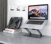 A laptop stand is shown on a desk next to a laptop. Podgląd zdjęcia produktu