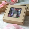 A gift box with a clear window, containing potpourri and two small bottles, possibly nail polish or perfume. Podgląd zdjęcia produktu