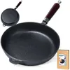 A cast iron frying pan is shown in the foreground, with a smaller, similar pan in the background. A product box is visible in the lower right corner. Podgląd zdjęcia produktu