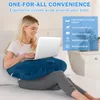 A woman is sitting on a bed using a laptop on a U-shaped pillow. Produktbild-Vorschau
