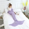 A woman is lying on a bed, wrapped in a purple mermaid tail blanket. Anteprima dell’immagine prodotto