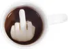 A white mug filled with a dark liquid, with a ceramic middle finger sculpture rising from the liquid. Produktbild-Vorschau