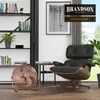 A modern living room with a bookshelf, a chair, and a fan. Podgląd zdjęcia produktu