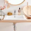 A bathroom sink area with various accessories. Anteprima dell’immagine prodotto
