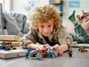 A young boy is playing with LEGOs on the floor. Náhled obrázku produktu