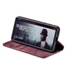 A smartphone in a burgundy flip case is displayed on a white background, showing a movie playing on the screen. Produktbild-Vorschau