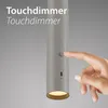 A hand is touching a touch-sensitive button on a cylindrical lamp. Anteprima dell’immagine prodotto