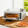 A stainless steel pizza oven with a pizza inside is shown on a wooden countertop, with a finished pizza and pizza peel on a wooden board in the foreground. Produktbild-Vorschau
