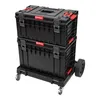 A black Qbrick System ONE Transportplattform 2.0 with red accents, stacked on top of itself and resting on a wheeled base. Produktbild-Vorschau