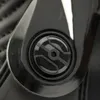 A close-up view of a black buckle or closure mechanism on a piece of gear, possibly motorcycle boots. Náhľad obrázku produktu