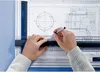 Hands using a drafting board with technical drawings. Anteprima dell’immagine prodotto