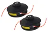 Two black string trimmer heads with orange trimmer line are shown against a white background. Podgląd zdjęcia produktu