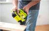 A person is using a yellow and black cordless jigsaw on a piece of wood. Produktbild-Vorschau
