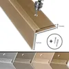 A close-up view of a bronze-colored stair nosing profile, showing a drill creating a hole for installation, along with dimensions and included hardware. Podgląd zdjęcia produktu