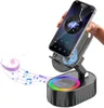 A hand holding a smartphone mounted on a black speaker stand with colorful LED lights. Produktbild-Vorschau