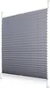 A gray pleated blind with white mounting brackets is shown against a white background. Produktbild-Vorschau