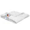 A folded white quilted blanket on a white background.