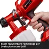 A close-up shot of a person holding a red paint sprayer. Produktbild-Vorschau
