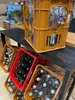A shelf unit holding several crates of beverages. Produktbild-Vorschau