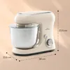 A cream-colored kitchen stand mixer is shown against a peach-colored background with dimension lines indicating its size. Produktbild-Vorschau