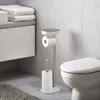 A modern bathroom setting with a toilet paper stand next to a toilet. Voir les images du produit