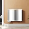 A white radiator mounted on a light brown wall. Podgląd zdjęcia produktu