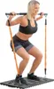 A woman is using a portable full-body training system. Podgląd zdjęcia produktu