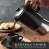 Coffee being poured into a small black cup from a black coffee maker. Produktbild-Vorschau