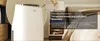 A white air conditioner unit is shown next to a bed in a bedroom setting, with text overlay describing its features. Produktbild-Vorschau