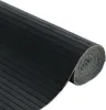 A rolled-up black rubber mat with a ribbed texture. Voir les images du produit