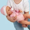 A person holding a baby doll. Produktbild-Vorschau