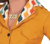 Close-up of a person wearing a yellow shirt with a colorful patterned collar and a gold 'DISCO' necklace. Produktbild-Vorschau